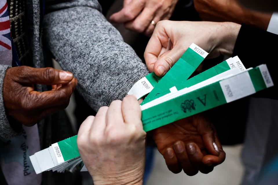 A close-up of wristbands being distributed