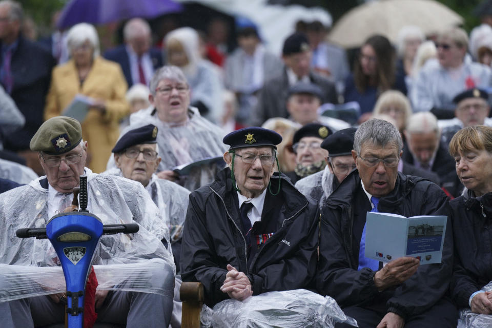 Veterans sing as they watch the official opening of the British Normandy Memorial in France via a live feed, during a ceremony at the National Memorial Arboretum in Alrewas, England, Sunday, June 6, 2021. Several ceremonies are scheduled on Sunday to commemorate the 77th anniversary of D-Day that led to the liberation of France and Europe from the German occupation. On June 6, 1944, more than 150,000 Allied troops landed on code-named beaches, carried by 7,000 boats. (Jacob King/PA via AP)
