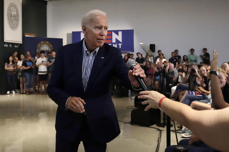 Democratic presidential candidate former Vice President Joe Biden hands a microphone to a questioner during a campaign event at Dartmouth College, Friday, Aug. 23, 2019, in Hanover, N.H. (AP Photo/Elise Amendola)