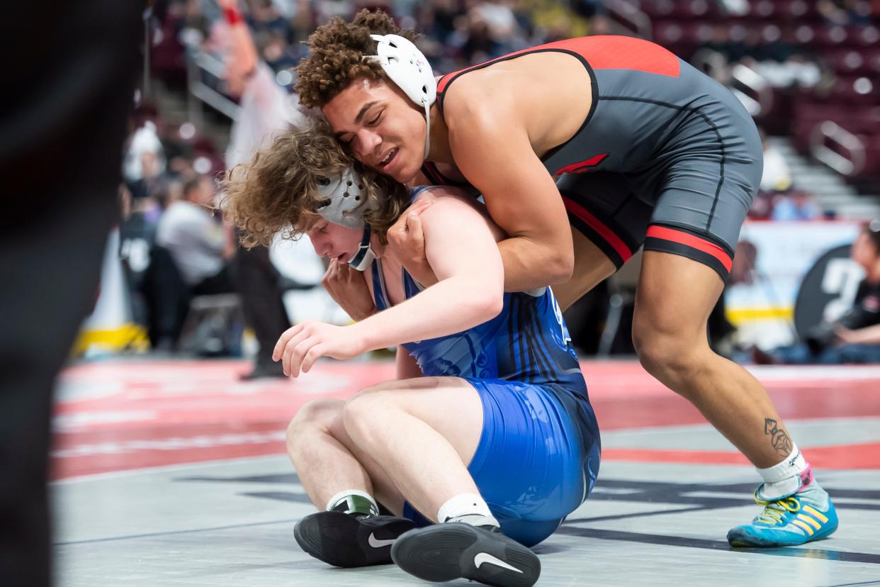 West Allegheny's Shawn Taylor, right, wrestles McDowell's Caleb Butterfield during a 160-pound round of 16 bout at the PIAA Class 3A Wrestling Championships at the Giant Center on Thursday, March 10, 2022, in Derry Township. Taylor won by decision, 9-4.