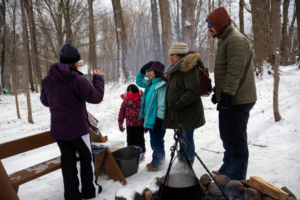 Families learn about maple syrup production during demonstrations Saturday, March 18, 2023, at Van Raalte Farm in Holland.
