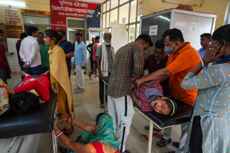 People suffering from heat related ailments crowd the district hospital in Ballia, Uttar Pradesh, India, on June 20. A scorching heat wave in two of India’s most populous states has overwhelmed hospitals, filled a morgue to capacity and disrupted power supply, forcing staff to use books to cool patients as officials investigate the climbing death toll.<span class="copyright">Rajesh Kumar Singh—AP</span>