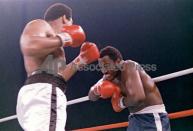 FILE - In this Oct. 1, 1975, file photo, heavyweight boxer Joe Frazier grimaces after Muhammad Ali, left, landed a blow to Frazier's head during their boxing bout in Manila, the Philippines. Ali won the fight after Frazier's manager stopped the fight in the 14th round. Frazier, the former heavyweight champion who handed Ali his first defeat yet had to live forever in his shadow, has died after a brief final fight with liver cancer. He was 67. The family issued a release confirming the boxer's death on Monday night, Nov. 7, 2011. (AP Photo/File)