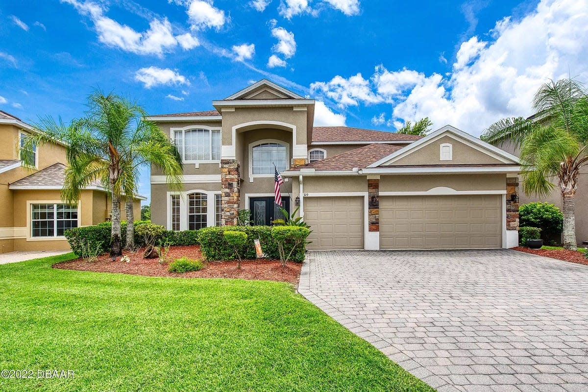 This lovely home overlooks the greens and a wooded preserve on hole 2 of The Hills golf course in Daytona Beac's LPGA community.