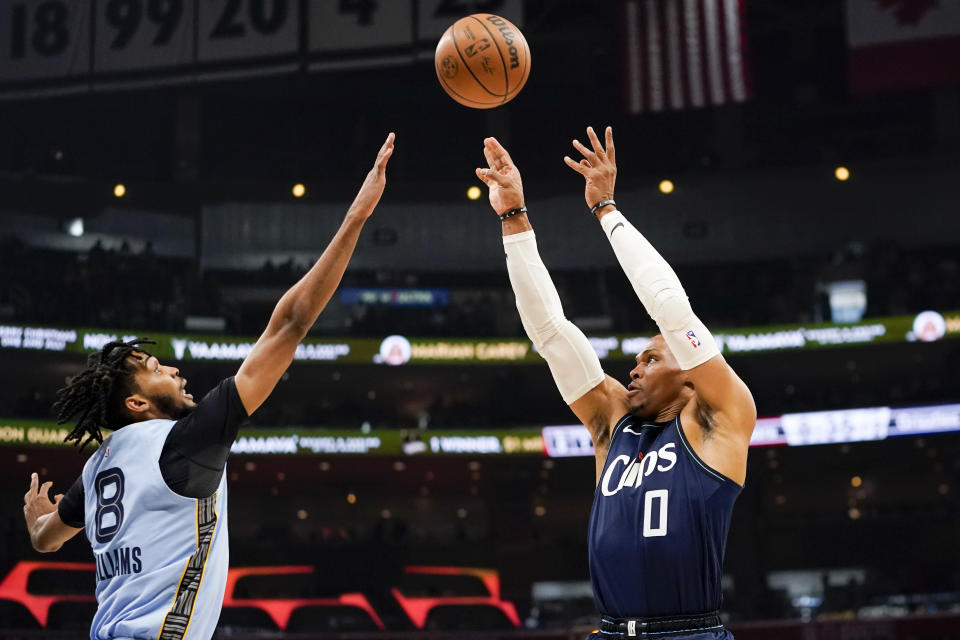 Los Angeles Clippers guard Russell Westbrook, right, shoots against Memphis Grizzlies forward Ziaire Williams during the first half of an NBA basketball game, Sunday, Nov. 12, 2023, in Los Angeles. (AP Photo/Ryan Sun)