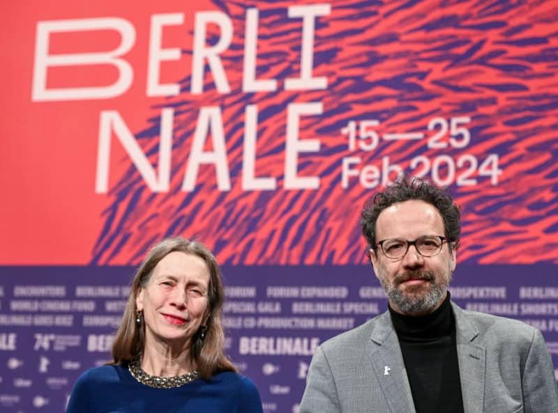 The management duo of the Berlinale, Mariette Rissenbeek (L), Managing Director, and Carlo Chatrian, Artistic Director, stand on stage before the start of the press conference announcing the 2024 Berlinale program. Jens Kalaene/dpa