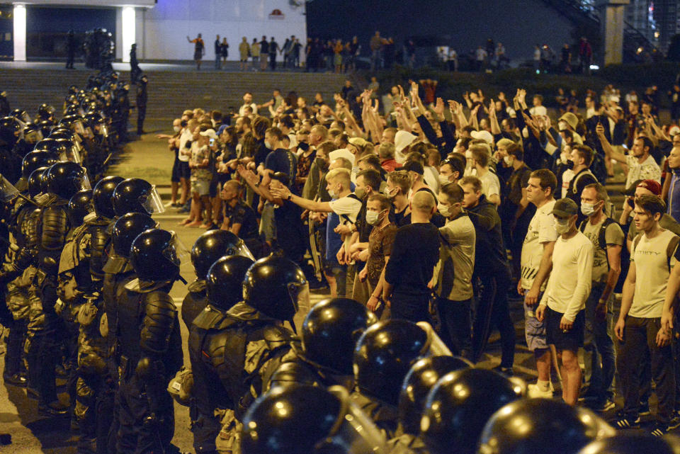 FILE - In this file photo taken on Sunday, Aug. 9, 2020, people argue with police during a rally after the Belarusian presidential election in Minsk, Belarus. Police and protesters clashed in Belarus' capital and the major city of Brest on Sunday after the presidential election in which the authoritarian leader who has ruled for a quarter-century sought a sixth term in office. (AP Photo, File)