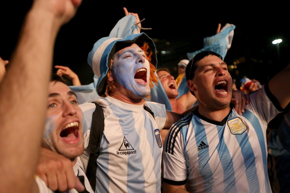 RIO DE JANEIRO, BRAZIL - JUNE 15: Argentine soccer fans cheer as they wait for their team to take to the field against Bosnia and Herzegovina as they watch on a giant screen at the FIFA World Cup Fan Fest on Copacabana beach on June 15, 2014 in Rio de Janeiro, Brazil. Their team is playing on the fourth day of the World Cup tournament. (Photo by Joe Raedle/Getty Images)