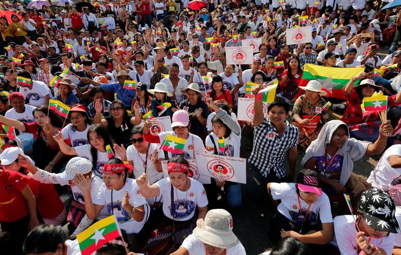 People gather to rally in support of Myanmar State Counsellor Aung San Suu Kyi before she heads off to the International Court of Justice (ICJ), in Yangon