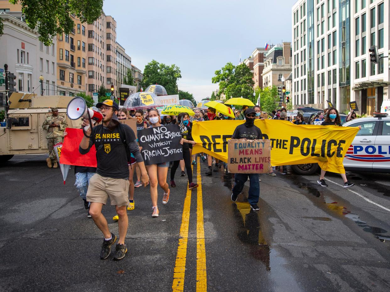 A group of Sunrise activists walk towards Black Lives Matter Plaza as people gather to celebrate Juneteenth in Washington DC (Getty Images)