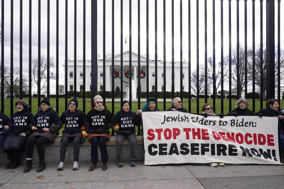 Activists with Jewish Voice for Peace, gather to protest the Israel-Hamas war in Gaza and chain themselves to the fence outside the White House, Monday, Dec. 11, 2023, in Washington. (AP Photo/Susan Walsh)