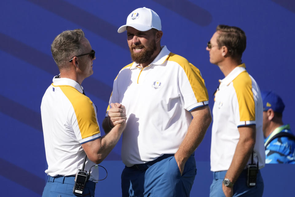 Europe's Team Captain Luke Donald , left shakes hands with Europe's Shane Lowry on the 1st tee during a practice round ahead of the Ryder Cup at the Marco Simone Golf Club in Guidonia Montecelio, Italy, Tuesday, Sept. 26, 2023. The Ryder Cup starts Sept. 29, at the Marco Simone Golf Club. (AP Photo/Andrew Medichini)