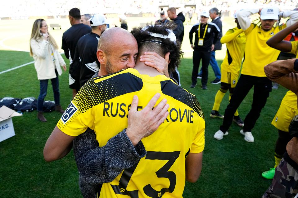 Oct 8, 2022; Columbus, Ohio, USA; Columbus Crew 2 head coach Lauren Courtois hugs Jacen Russell-Rowe (13) as they celebrate their win over St. Louis CITY2 in the MLS NEXT Pro Cup Championship at Lower.com Field. Mandatory Credit: Adam Cairns-The Columbus Dispatch