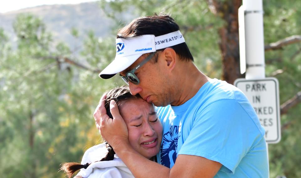 A man embraces his daughter after picking her up at Central Park, after a shooting at Saugus High School in Santa Clarita, Calif. on Nov. 14, 2019. (Photo: Frederic J. Brown/AFP/Getty Images)