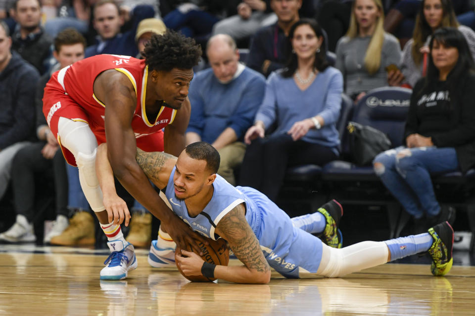 Minnesota Timberwolves guard Shabazz Napier, right, and Houston Rockets forward Danuel House Jr. battle for the ball during the first half of an NBA basketball game Friday, Jan. 24, 2020, in Minneapolis. (AP Photo/Craig Lassig)