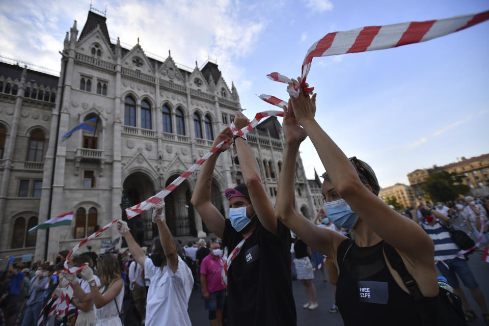 Students of the University of Theatre and Film Arts (SZFE) and their sympathizers form a human chain in protest against changes to the way the university is governed in Budapest, Hungary, Sunday, Sept. 6, 2020. (Marton Monus/MTI via AP)