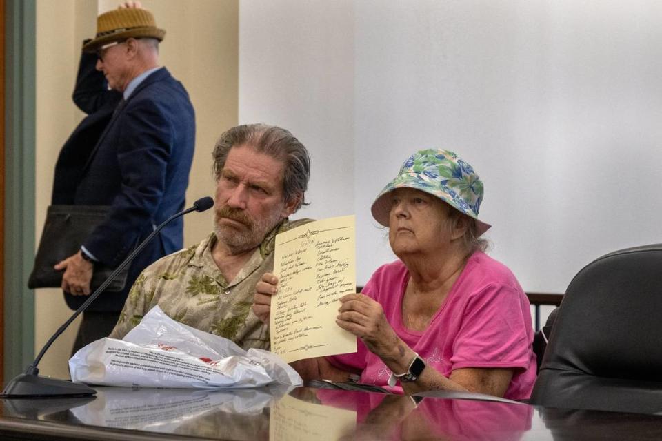 Linda Siegrist, 69, sits with husband Bruce as she holds up a list of stolen items she was hoping to submit in Sacramento Superior Court during a hearing on May 18 to decide whether her childhood home could be sold. Judge Richard K. Sueyoshi explained it was too late to submit the list. In the background, Dan Collins of the Bay Area Receivership Group – the company forcing the sale – departs the courtroom.