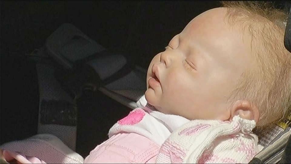 Police smashed through a  car window to rescue what they thought was a baby turned out to be child's play.