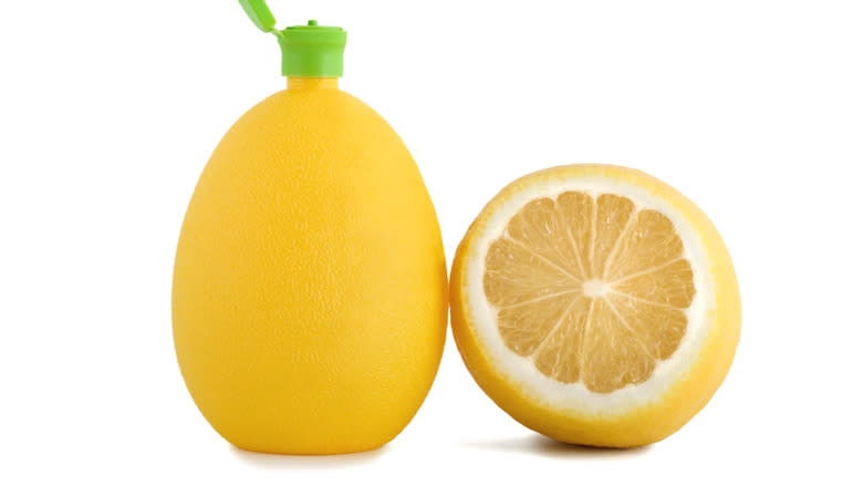 lemon juice bottle and fresh lemon