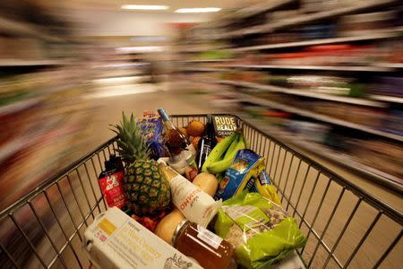 A shopping trolley is pushed around a supermarket in London, Britain May 19, 2015. REUTERS/Stefan Wermuth