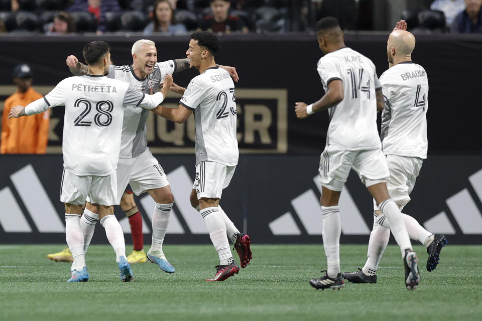 Toronto FC forward Federico Bernardeschi, second from left, celebrates a goal with teammates Raoul Petretta, left, and Brandon Servania, center, during the second half of an MLS soccer match against Atlanta United, Saturday, March 4, 2023, in Atlanta. (AP Photo/Alex Slitz)