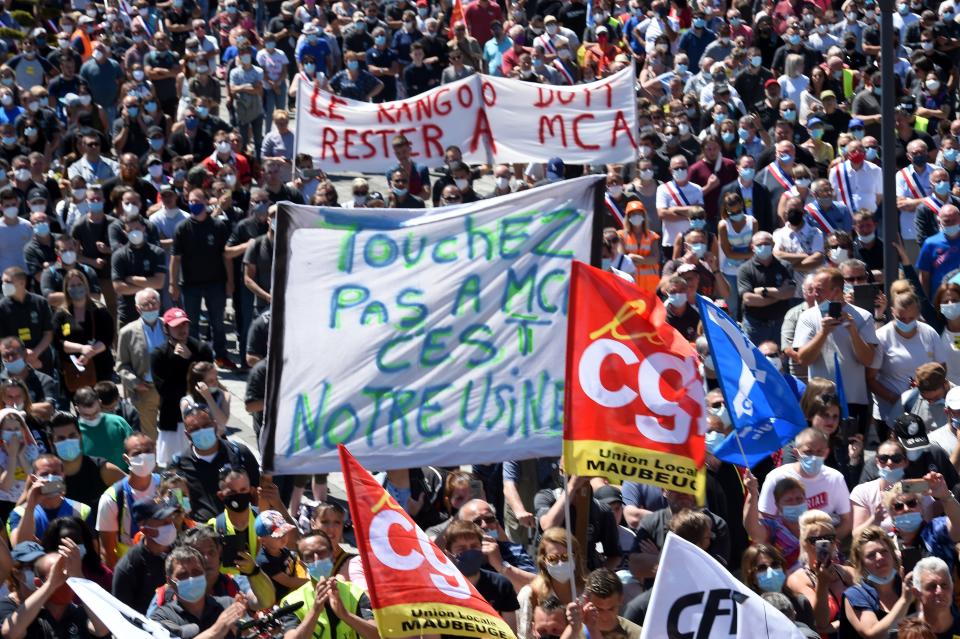Protester holds a banner reading " don't touch MCA its our plant" as they demonstrate against the Renault automaker's decision to cut 15,000 jobs worldwide, including 4,600 in France, in Maubeuge, on May 30, 2020, following the announcement of the Renault plant in Val de Sambre which is threatened by the savings plan. - The management of the manufacturer plans to transfer production of Kangoo electric utilities to the city of Douai 70 km away, which would inherit a new platform.   (Photo by FRANCOIS LO PRESTI / AFP) (Photo by FRANCOIS LO PRESTI/AFP via Getty Images)