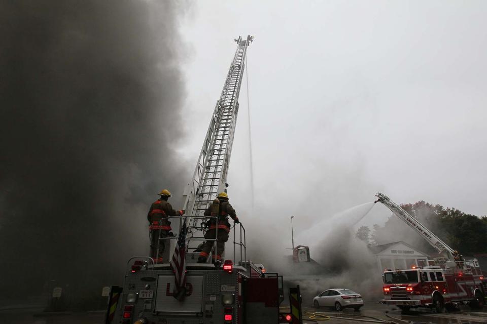 The Akron Fire Department works to bring a raging fire under control at Pavona’s Pizza Joint on Sand Run Road in Akron on Friday. The fire completely destroyed the restaurant.