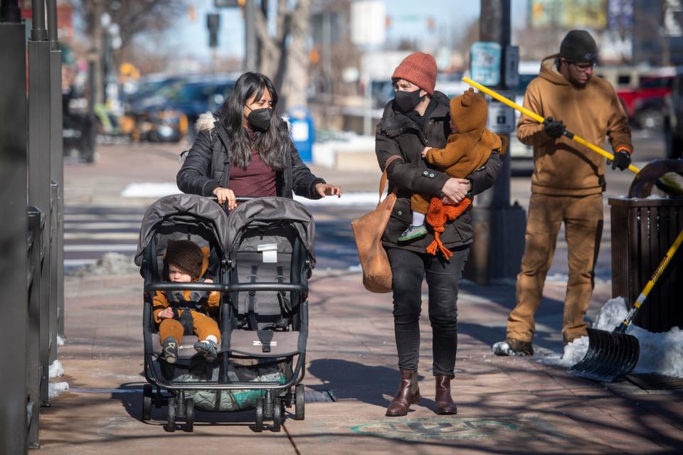 Monserrat Morales, left, and Brigid McAuiffee take a walk together Wednesday along North College Avenue in Old Town Fort Collins.