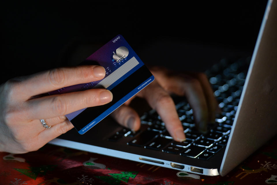 An illustrative image of a person holding a credit card while shopping on-line on a computer. On Sunday, January 3, 2021, in Dublin, Ireland. (Photo by Artur Widak/NurPhoto via Getty Images)