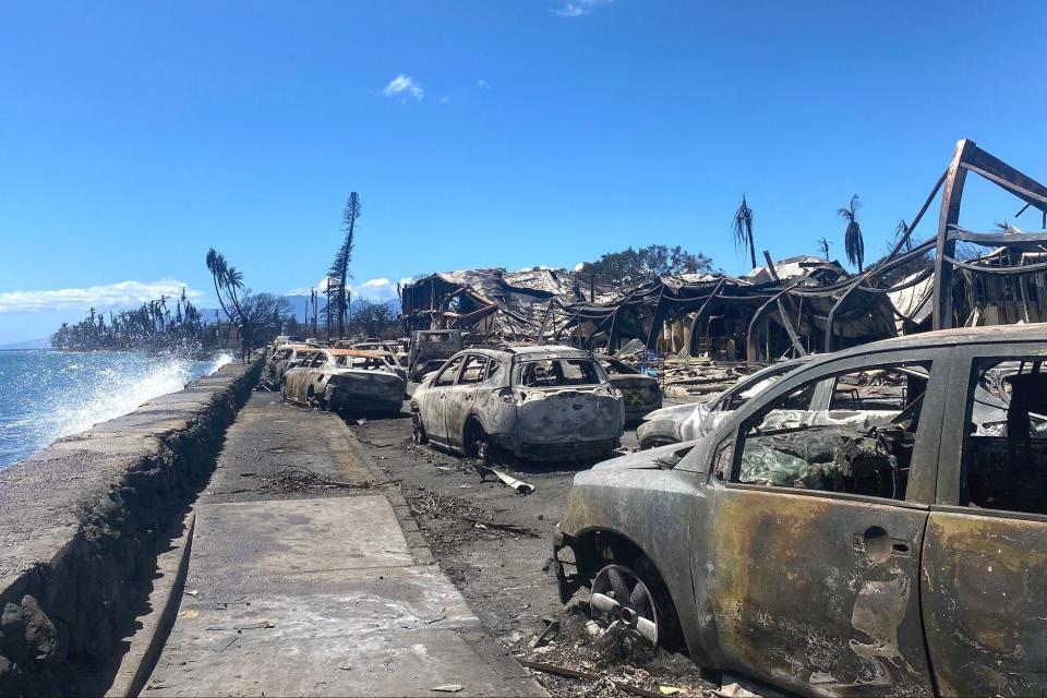 Burned cars and destroyed buildings are pictured in the aftermath of a wildfire in Lahaina, western Maui, Hawaii. The fire Aug. 8 killed at least 115 people.