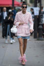 <p>Even though Giovanna Battaglia is wearing girly pink hues and heart-shaped sunglasses, she has still managed to make her mini look all grown up. Take your cue from her and dress it up with statement heels and an on-trend jacket.</p>