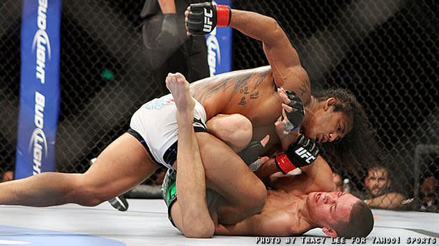 Benson Henderson pounds Nate Diaz on the ground.