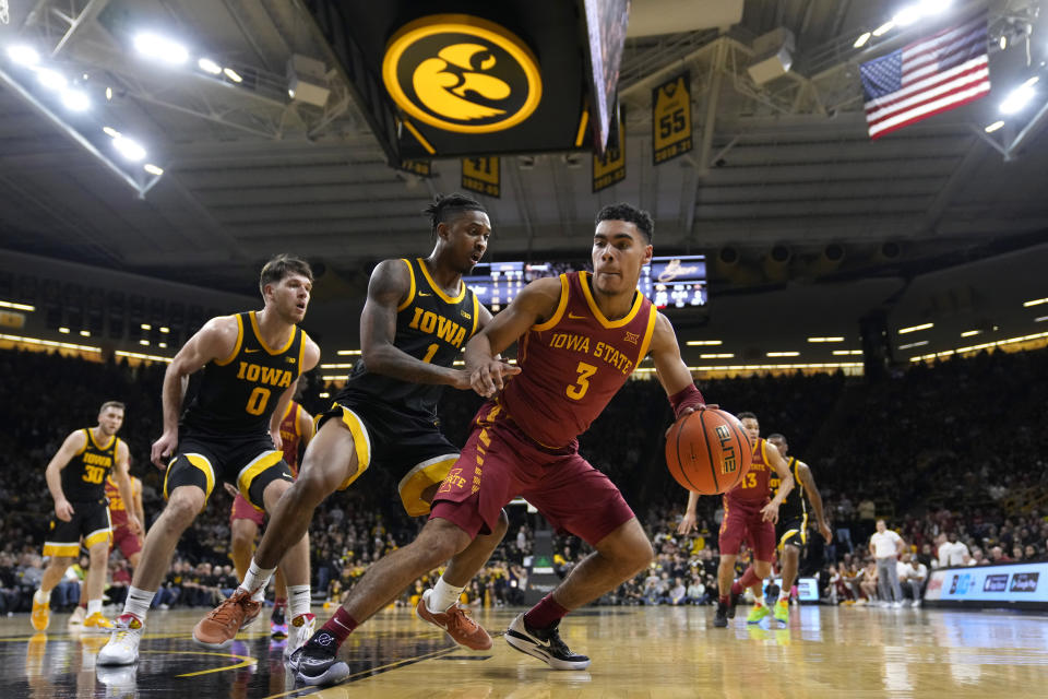 Iowa State guard Tamin Lipsey (3) looks to drive past Iowa guard Ahron Ulis (1) during the first half of an NCAA college basketball game, Thursday, Dec. 8, 2022, in Iowa City, Iowa. (AP Photo/Charlie Neibergall)