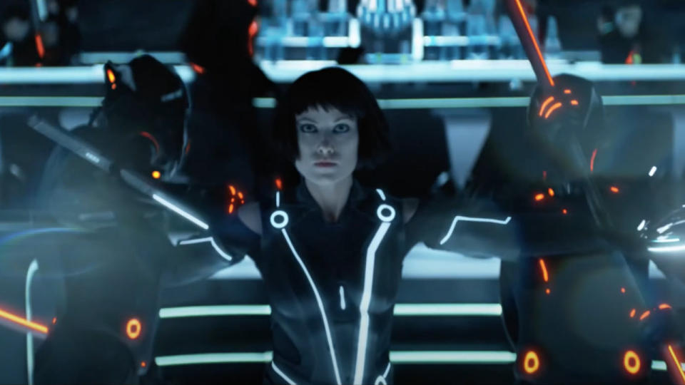 Olivia Wilde fights off two enemies in the End of Line Club in Tron: Legacy.