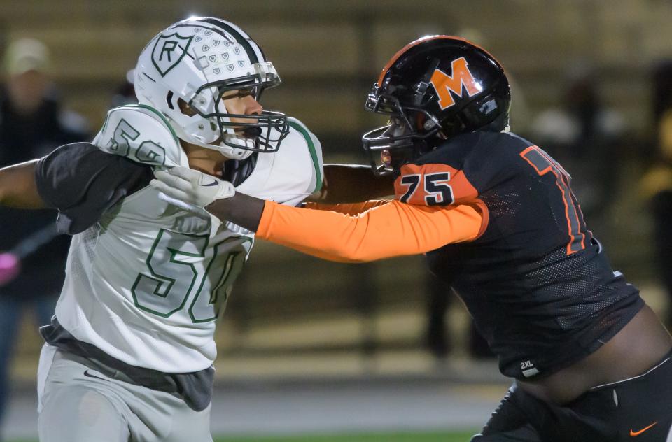 Manual's Nas King goes toe-to-toe with Richwoods' Ethan Carder in the first half of their Week 7 football game Friday, Oct. 6, 2023 at Peoria Stadium.