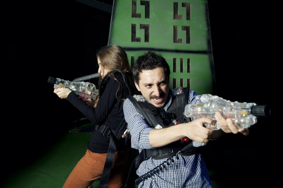 Adults playing laser tag