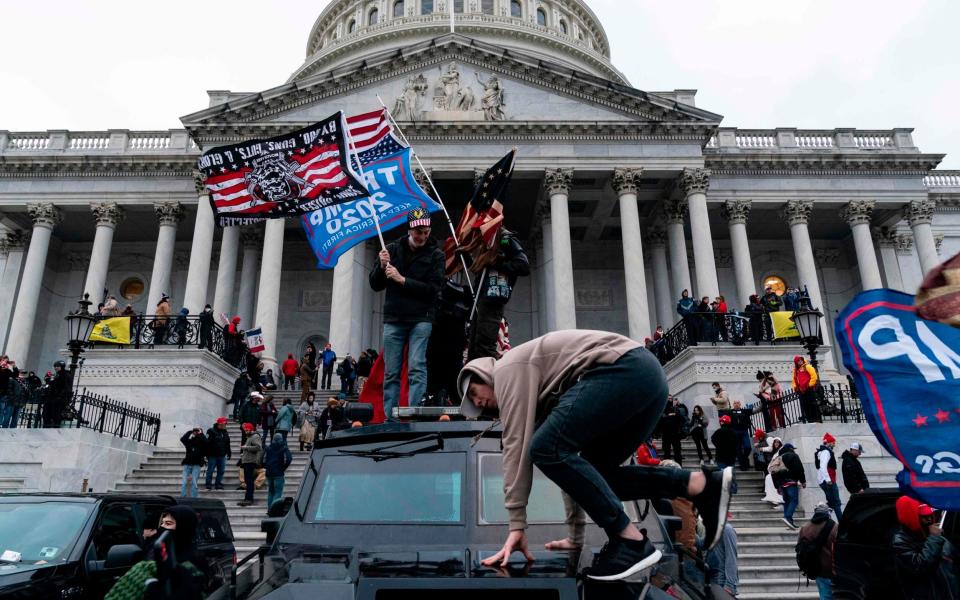 TOPSHOT - Supporters of US President Donald Trump protest outside the US Capitol on January 6, 2021, in Washington, DC. - Demonstrators breeched security and entered the Capitol as Congress debated the a 2020 presidential election Electoral Vote Certification. (Photo by ALEX EDELMAN / AFP) (Photo by ALEX EDELMAN/AFP via Getty Images) - LEX EDELMAN / AFP