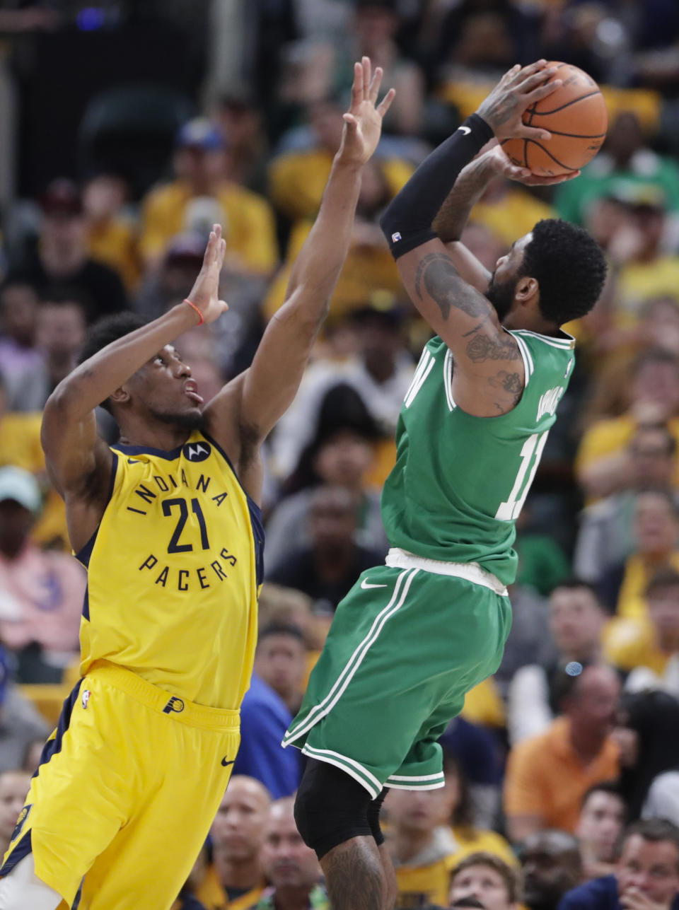 Boston Celtics guard Kyrie Irving (11) shoots over Indiana Pacers forward Thaddeus Young (21) during the second half of Game 4 of an NBA basketball first-round playoff series in Indianapolis, Sunday, April 21, 2019. The Celtics defeated the Pacers 110-106 to win the series 4-0. (AP Photo/Michael Conroy)