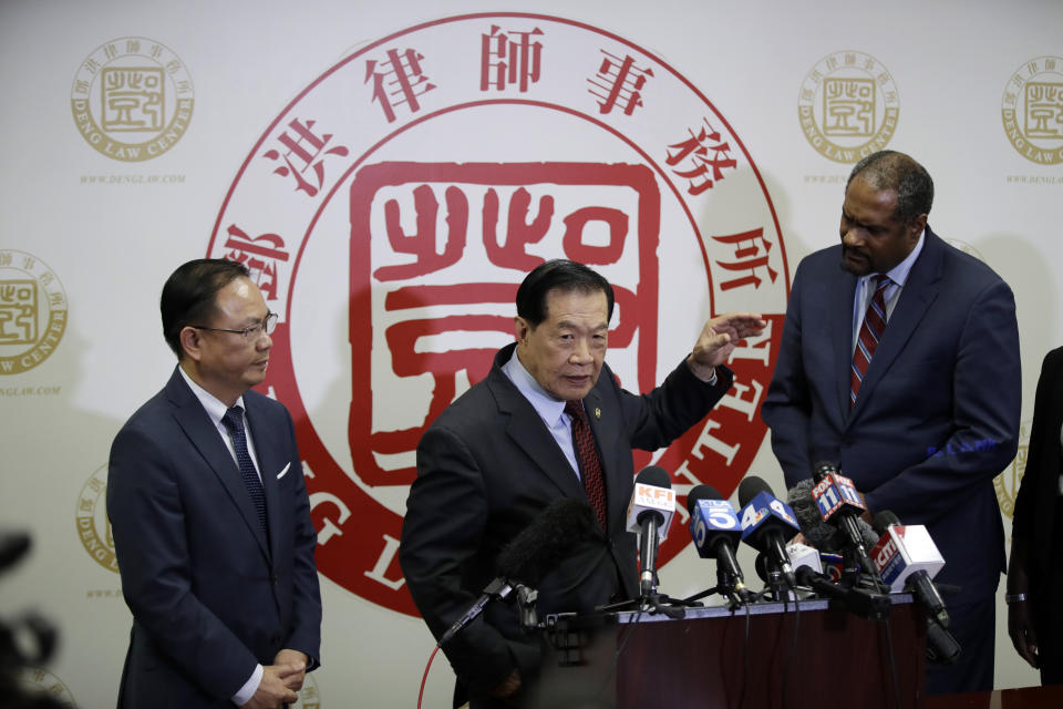 From left, attorney Daniel Deng, forensic scientist Henry Lee and attorney Brian Dunn hold a joint news conference regarding the fatal police shooting of Chinese immigrant Li Xi Wang Wednesday, Aug. 28, 2019, in Rosemead, Calif. Lawyers are pursuing claims against the city of Chino, Calif., for the fatal shooting of an unarmed man by a police officer who was part of team serving a search warrant on a suspected illegal marijuana operation. (AP Photo/Marcio Jose Sanchez)