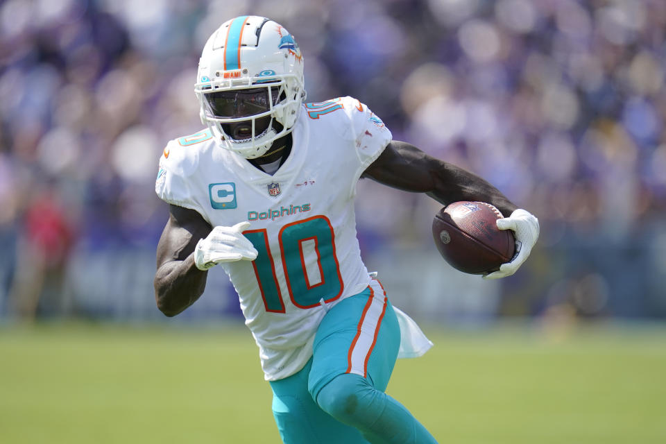 Miami Dolphins wide receiver Tyreek Hill (10) runs a play during the first half of an NFL football game against the Baltimore Ravens, Sunday, Sept. 18, 2022, in Baltimore. (AP Photo/Julio Cortez)