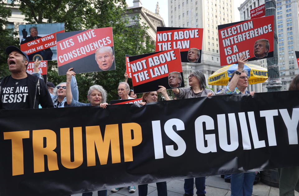 NEW YORK, UNITED STATES - MAY 30: Anti-Trump demonstrators gather with banners following Trump's hush money trial verdict in New York, United States on May 30, 2024. Donald Trump was found guilty Thursday of all 34 charges related to his hush money trial by a New York jury, making him the first former US president to be convicted of felony criminal charges. The 12-member jury reached their verdict after two full days of deliberations, finding Trump guilty of covering up a $130,000 hush money payment to adult film star Stormy Daniels to keep her story of their alleged affair from being published during the 2016 presidential election and itemizing it as a business expense. (Photo by Selcuk Acar/Anadolu via Getty Images)