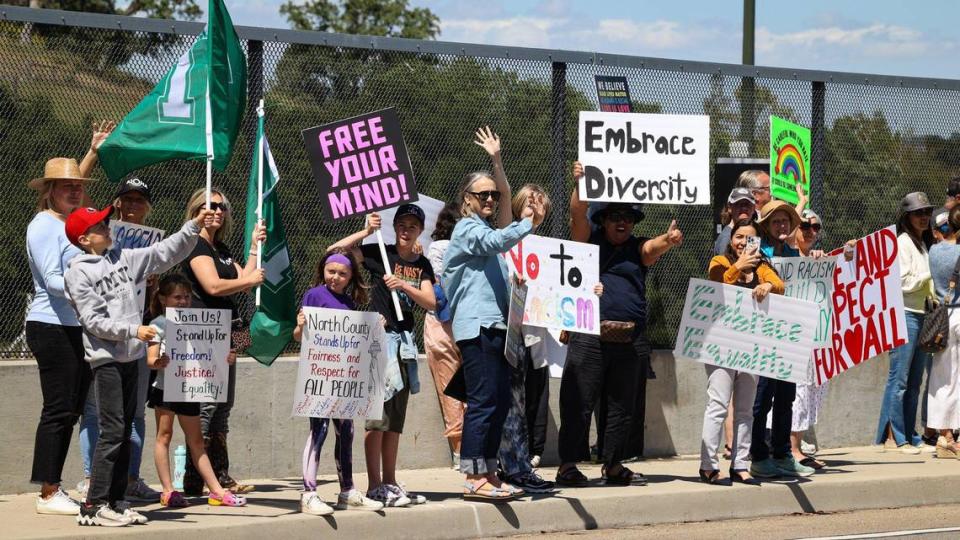 More than 100 people gathered to support diversity in the first hour of a rally on the Vineyard Drive Highway 101 overpass in Templeton on May 10, 2023. The gathering was a response to a social media post showing a pair of people holding an “Embrace white pride” banner there last week.