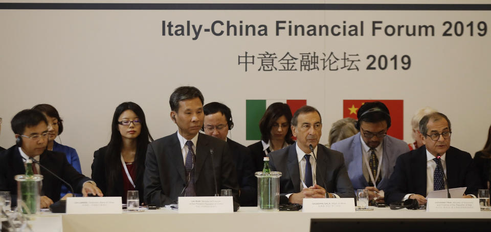 From left, Bank of China chairman, Liu Liange, Chinese Minister of Finance, Liu Kun, Milan's mayor Giuseppe Sala and Italy's Minister of Economy Giovanni Tria attend the Italy-China Financial forum, at Palazzo Marino town hall, in Milan, Italy, Wednesday, July 10, 2019. (AP Photo/Luca Bruno)