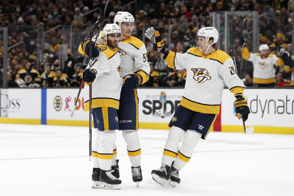 Nashville Predators' Luke Kunin (11) is congratulated by Philippe Myers and Matt Luff, right, after his goal against the Boston Bruins during the second period of an NHL hockey game Saturday, Jan. 15, 2022, in Boston. (AP Photo/Winslow Townson)