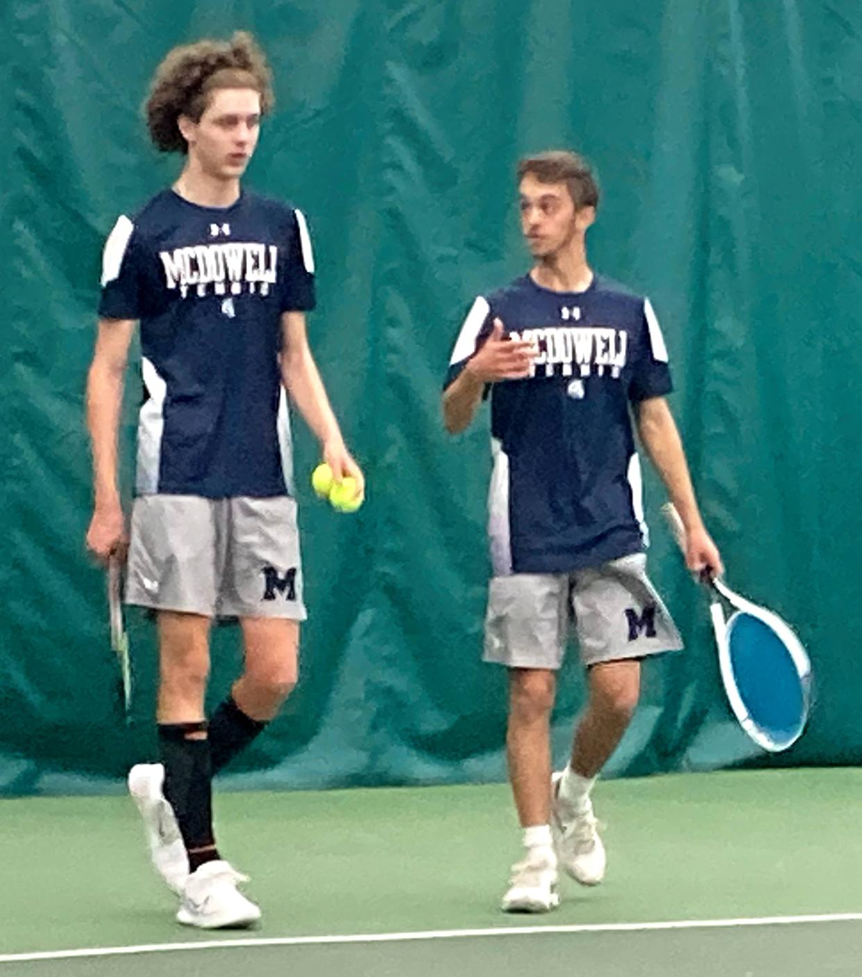 McDowell's Noah Hardesty and Gridley Wright discuss strategy during a changeover amid Wednesday's final for District 10's Class 3A boys doubles tennis tournament at Westwood Racquet Club. Hardesty and Wright beat Trojan teammates Christian Neubert and Dan Idzik 6-1, 6-2.
