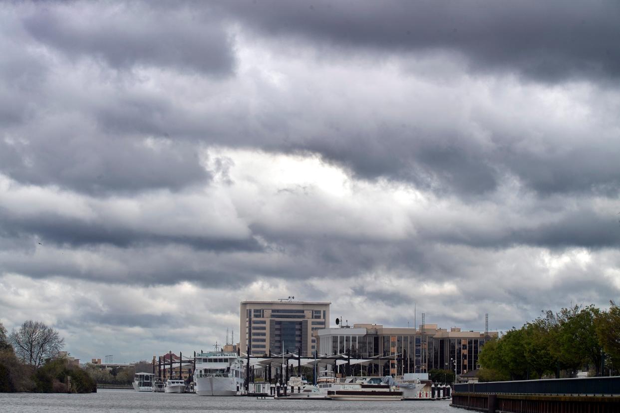 Dramatic clouds hover above downtown Stockton turning basin after morning rain showers on Wednesday, Mar. 22, 2023.