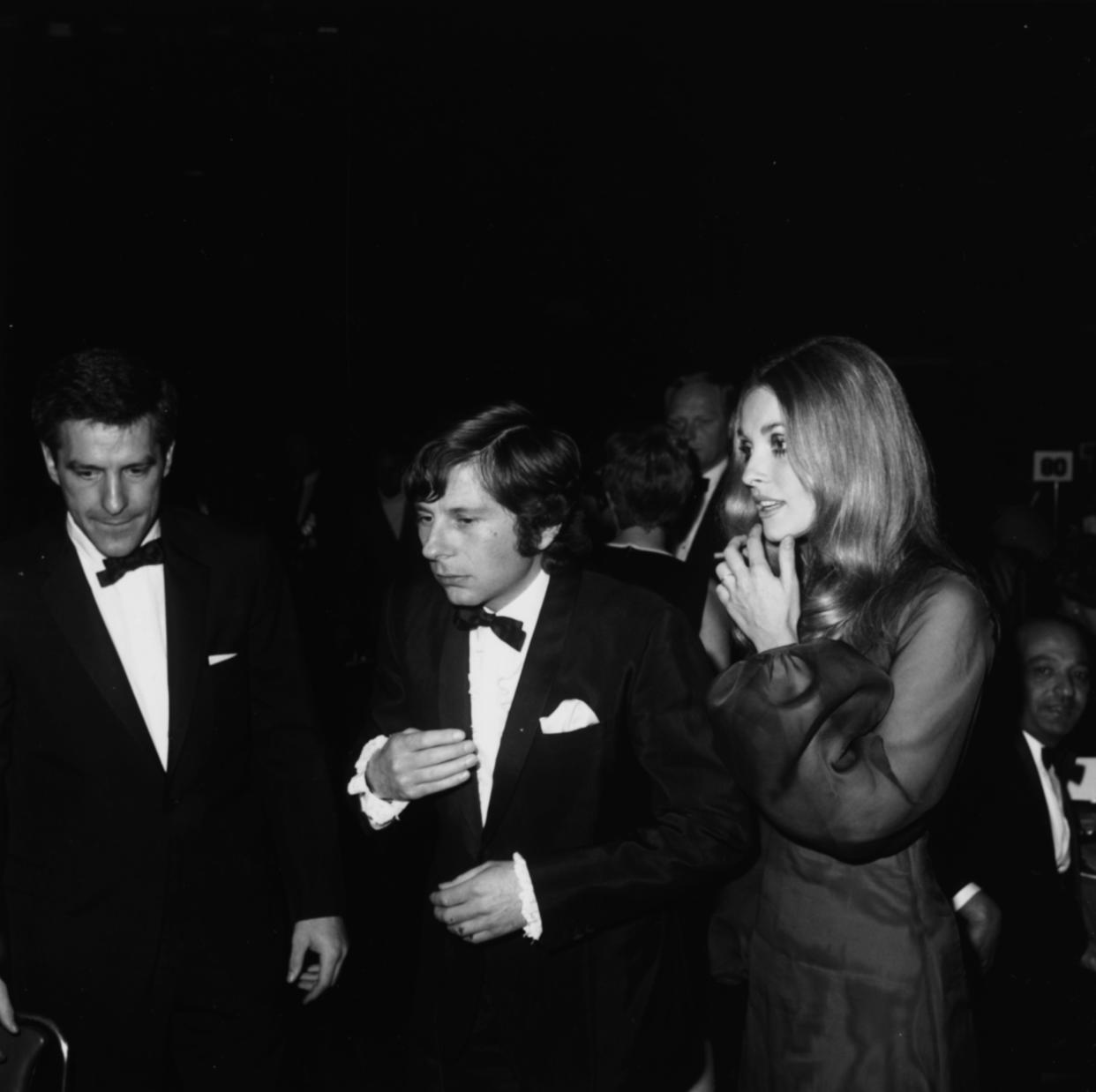 The auction will include the chocolate sheer silk Alba gown Tate — pictured with John Cassavetes, left, and Polanski — wore to the 1968 Golden Globes. (Photo: Max B. Miller/Fotos International/Archive Photos/Getty Images)