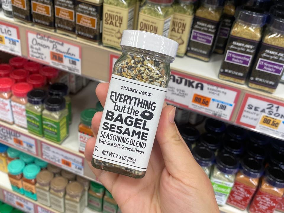 hand holding bottle of everything but the bagel sesame seasoning blend from trader joes