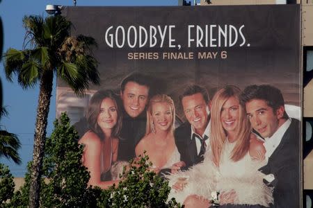 The cast of the popular comedy television series "Friends," are pictured on a giant billboard promoting the series finale, at the NBC television network office in Burbank, California, May 3, 2004. REUTERS/Fred Prouser/Files