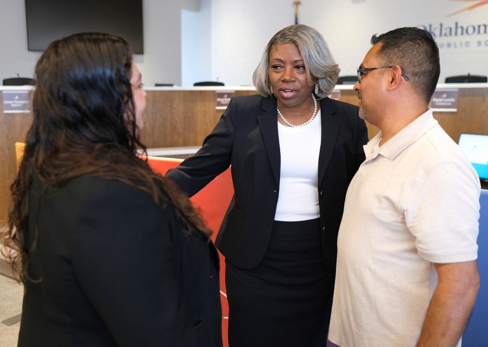 Board members Jessica Cifuentes, left, and Juan Lecona, right, congratulate Dr. Jamie Polk on May 11. The Oklahoma City Public Schools (OKCPS) Board of Education selected Polk as the district's next superintendent.